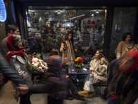 Young Iranian women are outside a cafe during Christmas shopping in downtown Tehran, Iran, on December 13, 2024. While Iranian-Christians ce...