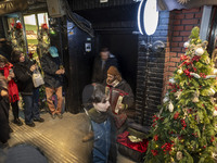 An Iranian street musician plays the accordion on a sidewalk during Christmas shopping in downtown Tehran, Iran, on December 13, 2024. Irani...