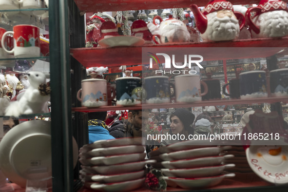 An Iranian couple talks to each other while shopping for Christmas in downtown Tehran, Iran, on December 13, 2024. Iranian-Christians celebr...