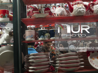 An Iranian couple talks to each other while shopping for Christmas in downtown Tehran, Iran, on December 13, 2024. Iranian-Christians celebr...