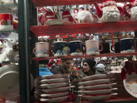 An Iranian couple talks to each other while shopping for Christmas in downtown Tehran, Iran, on December 13, 2024. Iranian-Christians celebr...