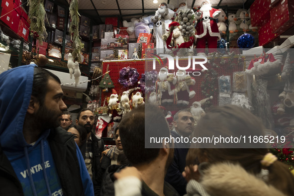 An Iranian-Christian man looks at Christmas accessories while shopping in downtown Tehran, Iran, on December 13, 2024. Iranian-Christians ce...