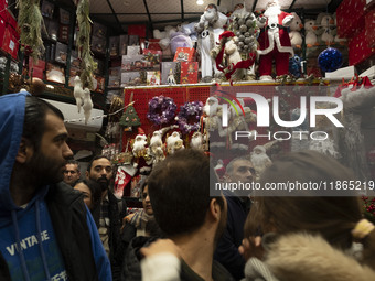 An Iranian-Christian man looks at Christmas accessories while shopping in downtown Tehran, Iran, on December 13, 2024. Iranian-Christians ce...