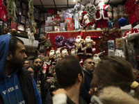 An Iranian-Christian man looks at Christmas accessories while shopping in downtown Tehran, Iran, on December 13, 2024. Iranian-Christians ce...