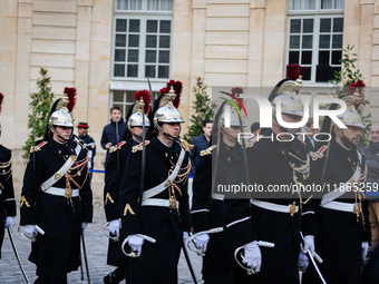 The French Republican Guard is seen before the handover ceremony between Michel Barnier, the outgoing Prime Minister, and Francois Bayrou, t...