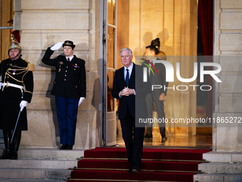 In Paris, France, on December 13, 2024, Michel Barnier, the resigning prime minister, awaits arrival at the Matignon entrance during the han...