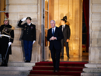 In Paris, France, on December 13, 2024, Michel Barnier, the resigning prime minister, awaits arrival at the Matignon entrance during the han...