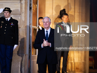 In Paris, France, on December 13, 2024, Michel Barnier, the resigning prime minister, awaits arrival at the Matignon entrance during the han...