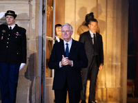 In Paris, France, on December 13, 2024, Michel Barnier, the resigning prime minister, awaits arrival at the Matignon entrance during the han...