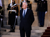 In Paris, France, on December 13, 2024, Michel Barnier, the resigning prime minister, awaits arrival at the Matignon entrance during the han...