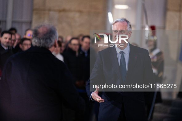 In Paris, France, on December 13, 2024, Michel Barnier, the resigning prime minister, receives Francois Bayrou at the Matignon entrance duri...