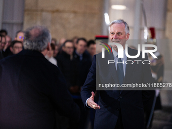 In Paris, France, on December 13, 2024, Michel Barnier, the resigning prime minister, receives Francois Bayrou at the Matignon entrance duri...