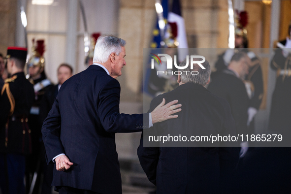 In Paris, France, on December 13, 2024, Michel Barnier, the resigning prime minister, receives Francois Bayrou at the Matignon entrance duri...