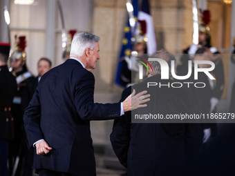 In Paris, France, on December 13, 2024, Michel Barnier, the resigning prime minister, receives Francois Bayrou at the Matignon entrance duri...