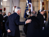 In Paris, France, on December 13, 2024, Michel Barnier, the resigning prime minister, receives Francois Bayrou at the Matignon entrance duri...