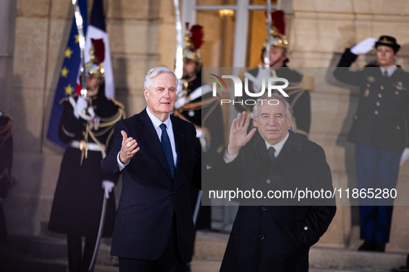 In Paris, France, on December 13, 2024, Michel Barnier, the resigning prime minister, receives Francois Bayrou at the Matignon entrance duri...