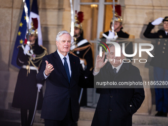 In Paris, France, on December 13, 2024, Michel Barnier, the resigning prime minister, receives Francois Bayrou at the Matignon entrance duri...