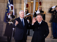 In Paris, France, on December 13, 2024, Michel Barnier, the resigning prime minister, receives Francois Bayrou at the Matignon entrance duri...