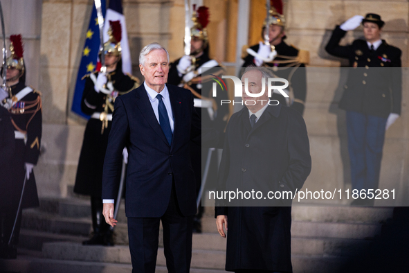 In Paris, France, on December 13, 2024, Michel Barnier, the resigning prime minister, receives Francois Bayrou at the Matignon entrance duri...