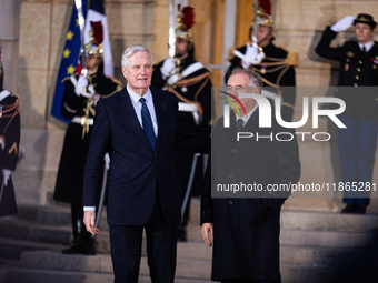 In Paris, France, on December 13, 2024, Michel Barnier, the resigning prime minister, receives Francois Bayrou at the Matignon entrance duri...