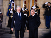 In Paris, France, on December 13, 2024, Michel Barnier, the resigning prime minister, receives Francois Bayrou at the Matignon entrance duri...