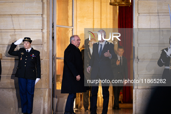 In Paris, France, on December 13, 2024, Michel Barnier, the resigning prime minister, receives Francois Bayrou at the Matignon entrance duri...