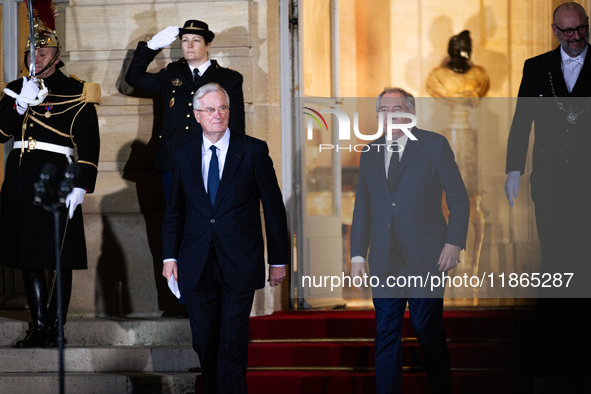 Michel Barnier, the resigning prime minister, and Francois Bayrou, the new French Prime Minister, are seen at the Matignon entrance during t...