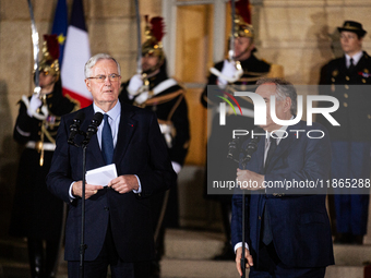 Michel Barnier, the resigning prime minister, and Francois Bayrou, are seen during the speech of the handover ceremony between Michel Barnie...