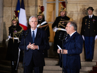 Michel Barnier, the resigning prime minister, and Francois Bayrou, are seen during the speech of the handover ceremony between Michel Barnie...