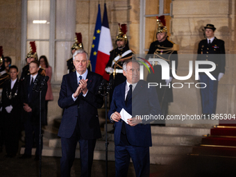 Michel Barnier, the resigning prime minister, and Francois Bayrou, are seen during the speech of the handover ceremony between Michel Barnie...