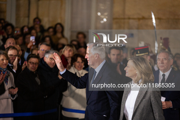 Michel Barnier, the resigning Prime Minister, departs at the end of the handover ceremony with his wife Isabelle Altmayer during the ceremon...