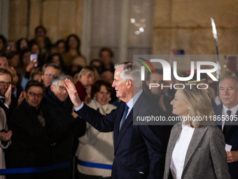 Michel Barnier, the resigning Prime Minister, departs at the end of the handover ceremony with his wife Isabelle Altmayer during the ceremon...