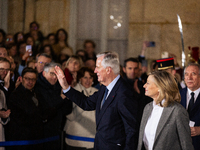 Michel Barnier, the resigning Prime Minister, departs at the end of the handover ceremony with his wife Isabelle Altmayer during the ceremon...