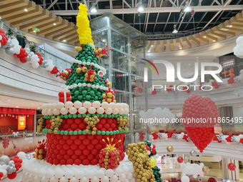 A 10-meter-high ''Christmas tree'' is decorated with colorful balloons and a ''heart'' in the atrium of a shopping mall in Xi'an, China, on...