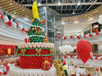 A 10-meter-high ''Christmas tree'' is decorated with colorful balloons and a ''heart'' in the atrium of a shopping mall in Xi'an, China, on...