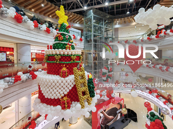 A 10-meter-high ''Christmas tree'' is decorated with colorful balloons and a ''heart'' in the atrium of a shopping mall in Xi'an, China, on...