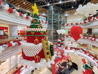 A 10-meter-high ''Christmas tree'' is decorated with colorful balloons and a ''heart'' in the atrium of a shopping mall in Xi'an, China, on...