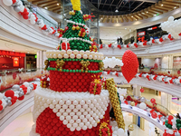 A 10-meter-high ''Christmas tree'' is decorated with colorful balloons and a ''heart'' in the atrium of a shopping mall in Xi'an, China, on...