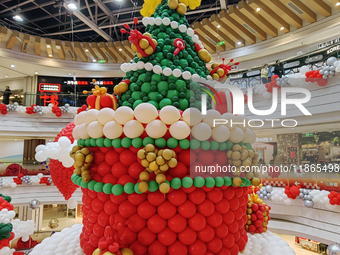 A 10-meter-high ''Christmas tree'' is decorated with colorful balloons and a ''heart'' in the atrium of a shopping mall in Xi'an, China, on...