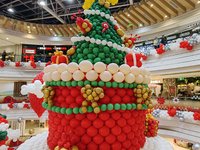 A 10-meter-high ''Christmas tree'' is decorated with colorful balloons and a ''heart'' in the atrium of a shopping mall in Xi'an, China, on...