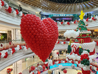 A 10-meter-high ''Christmas tree'' is decorated with colorful balloons and a ''heart'' in the atrium of a shopping mall in Xi'an, China, on...