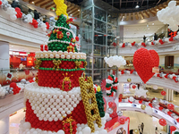 A 10-meter-high ''Christmas tree'' is decorated with colorful balloons and a ''heart'' in the atrium of a shopping mall in Xi'an, China, on...