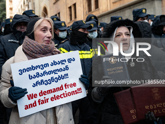 On December 14, 2024, in Tbilisi, Georgia, anti-government protesters gather during a demonstration against the Georgian government's postpo...