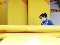 A worker produces surfboards for export to Europe and the United States at a production workshop in Suqian, Jiangsu province, China, on Dece...