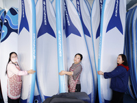 Workers produce surfboards for export to Europe and the United States at a production workshop in Suqian, Jiangsu province, China, on Decemb...