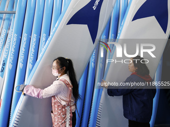 Workers produce surfboards for export to Europe and the United States at a production workshop in Suqian, Jiangsu province, China, on Decemb...