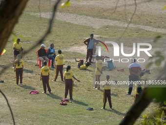 Indian school children practice their school drill at a ground in Siliguri, India, on December 14, 2024. (