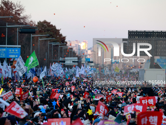 Citizens cheer after the impeachment of President Yoon Suk-yeol is passed in Seoul, South Korea, on December 14, 2024. Approximately 2 milli...