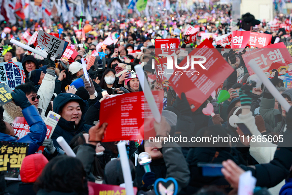 Citizens cheer after the impeachment of President Yoon Suk-yeol is passed in Seoul, South Korea, on December 14, 2024. Approximately 2 milli...