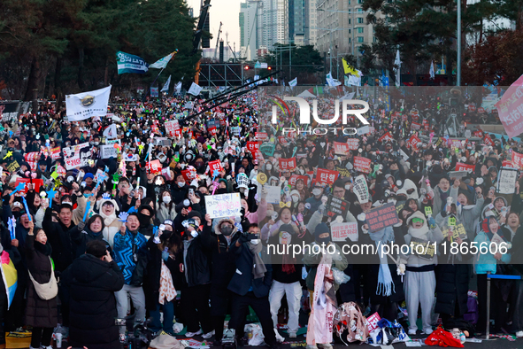 Citizens cheer after the impeachment of President Yoon Suk-yeol is passed in Seoul, South Korea, on December 14, 2024. Approximately 2 milli...